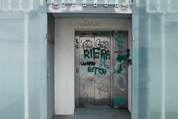 Modern lift door with graffiti on it.