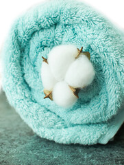 Flowers composition. Cotton flowers on bath towel background.