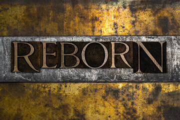 Reborn text message on textured grunge copper and vintage gold background