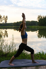 Fototapeta premium A woman enjoys wildlife on a lake. The concept of relieving stress in nature.