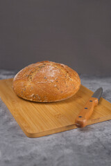 loaf of bread and a knife on cutting board