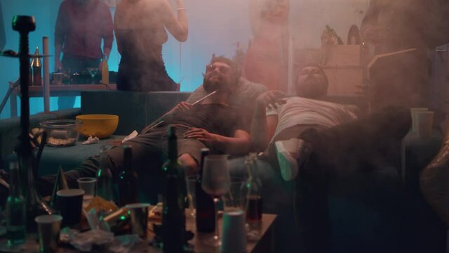 Drunk men talking during night party