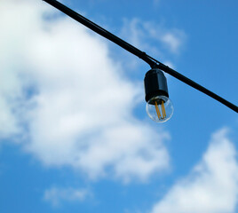 Street light. Blue sky. White clouds. Foreground