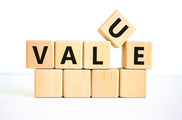 Value symbol. The concept word 'value' on wooden cubes on a beautiful white table, white background, copy space. Business and value concept.