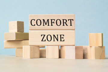 COMFORT ZONE word on wooden cubes on white desk.