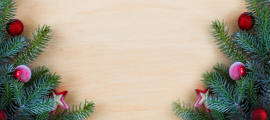 Christmas fir tree with decoration on a wooden board. Copy space. Selective focus. Banner