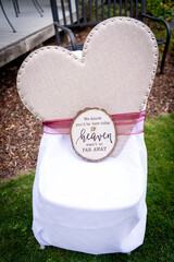 Decorated chair at a wedding reception outdoors