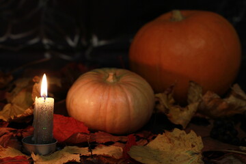 Orange pumpkins are a symbol of the holiday - All Saints Day. Subdued light. Evening by candlelight.