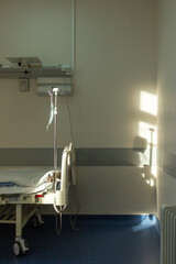 hospital bed in the room medical mask hanging next to the bed