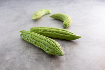A view of several units of bitter melon scattered on a surface.