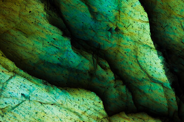 labradorite Detail of colorful multicolored (green, cyan, yellow) macro gemstone. Close-up of the...