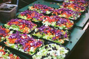 A view of a table filled with salad meal prep containers.