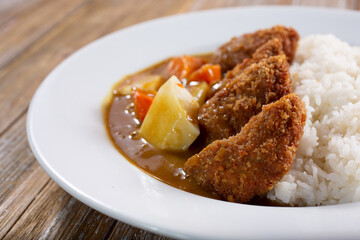 A view of a plate of chicken curry.