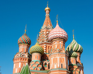 Fototapeta na wymiar The domes of St. Basil's Cathedral with golden crosses against the blue sky. Red Square, Moscow, Russia. Close-up.