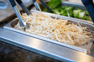 A view of a steamer pan filled with raw bean sprouts, seen at a local buffet restaurant.