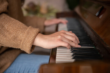 Fototapeta premium Close-up of female hands playing the piano.