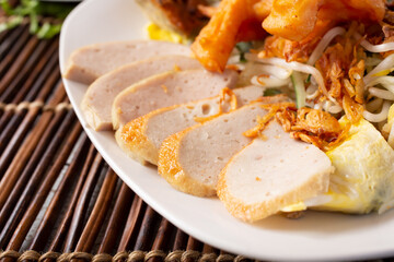 A closeup view of slices of fish cake, part of an Asian entree.