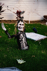 The front lawn is decorated with skeletons, graves and ghosts for the Halloween celebration. Halloween background