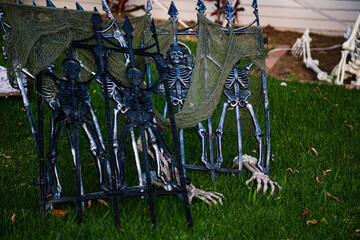 The front lawn is decorated with skeletons, graves and ghosts for the Halloween celebration. Halloween background