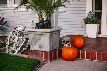 The front lawn is decorated with skeletons, graves and ghosts for the Halloween celebration. Halloween background