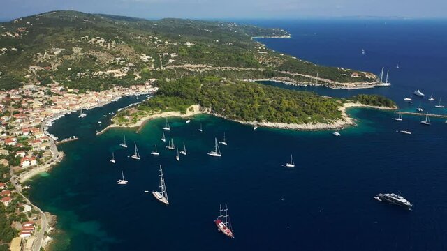 Aerial drone video of iconic port of Gaios a natural fjord bay ideal for safe anchorage in island of Paxos, Ionian, Greece