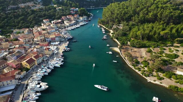 Aerial drone video of iconic port of Gaios a natural fjord bay ideal for safe anchorage in island of Paxos, Ionian, Greece