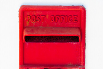 Red post office box affixed to a wall.