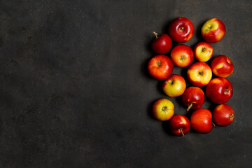 Fresh red apples on a black background. Fruits. Top view. Free space for text.