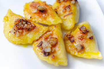 Fried dumplings sprinkled with fried onion, traditional Polish, Russian and Ukrainian cuisine