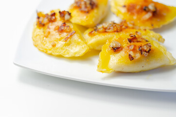Fried dumplings sprinkled with fried onion, traditional Polish, Russian and Ukrainian cuisine