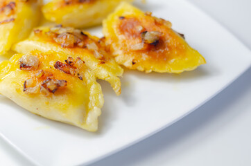 Fried dumplings sprinkled with fried onion, traditional Polish, Russian and Ukrainian cuisine