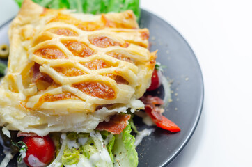 Chicken en croute, chicken breast inner fillets with mature cheddar cheese and beechwood smoked streaky bacon in a puff pastry lattice