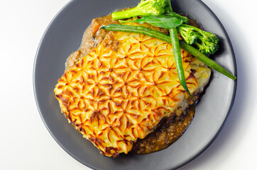 Tender minced lamb with garden veg in a hearty gravy beneath butter mash, typical Shepherd's pie