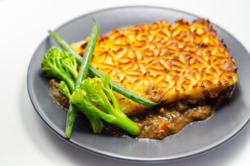 Tender minced lamb with garden veg in a hearty gravy beneath butter mash, typical Shepherd's pie
