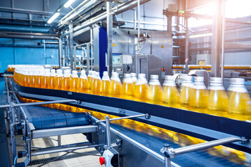Conveyor belt with bottles for juice or water at a modern beverage plant