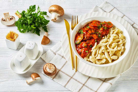 spaetzle with mushroom gravy in a white bowl