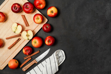 Fresh red apples with cinnamon on a black background. Apple baking seasonal concept. Fruits. Top view. Free space for text.