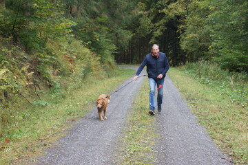 Man with his dog a golden retriever