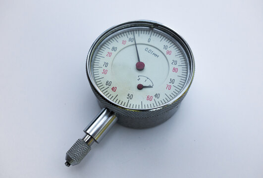A metal curvimeter on a white isolate. A mechanical device with a scale and divisions. An accurate measuring device.
