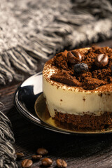 Cake with coffee beans and blueberry on the dark wooden backdrop 