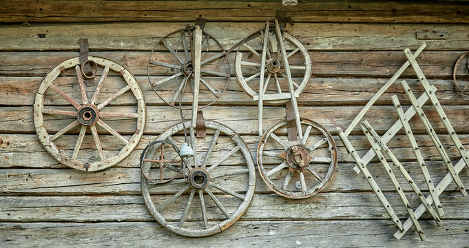 Old wooden wheels on a wooden wall