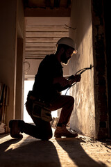 Worker is cutting wires with lineman's pliers.