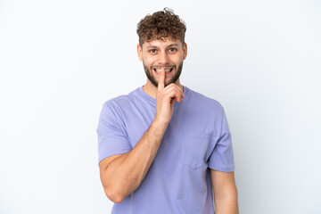 Fototapeta na wymiar Young handsome caucasian man isolated on white background showing a sign of silence gesture putting finger in mouth