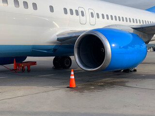 Close-up of an airplane engine, parking and checking air transport before departure, checking the turbine of an airplane on the runway of an airfield or airport