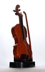 Toy Violin and bow on a stand in high key