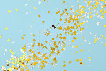 New Year, Christmas, or Birthday background. Scattered holiday confetti, stars and glitter.