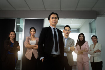 Confident leader hands in pocket with success and confident happy teamwork various culture members standing at front meeting room, Teamwork of Employee, Business vision, Leadership concept