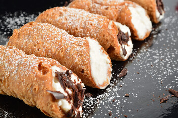 Homemade sicilian cannoli with ricotta and chocolate chips. Shallow DOF.