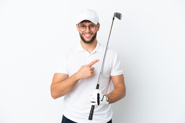 Handsome young man playing golf  isolated on white background pointing to the side to present a product