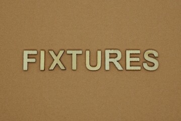 gray word fixtures made of wooden letters on brown background